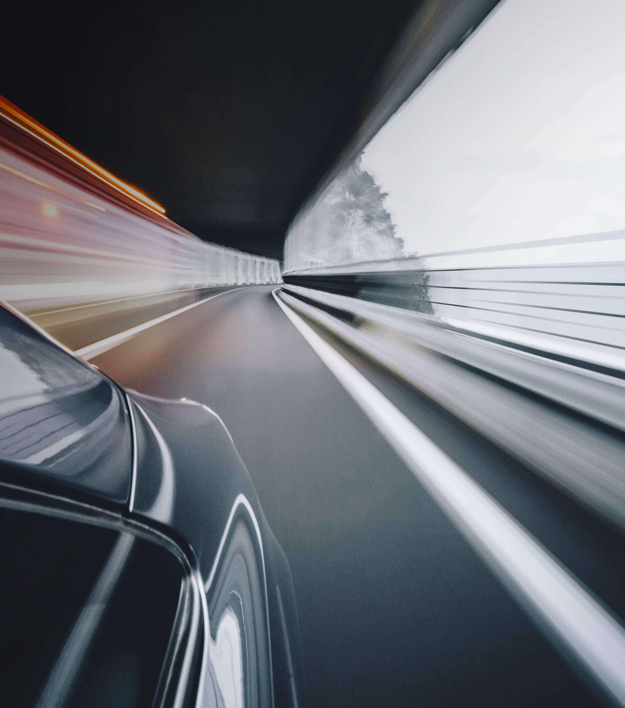 Car speeding through a cliff-side road